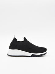 Zapatilla slip on negra de punto con suela blanca