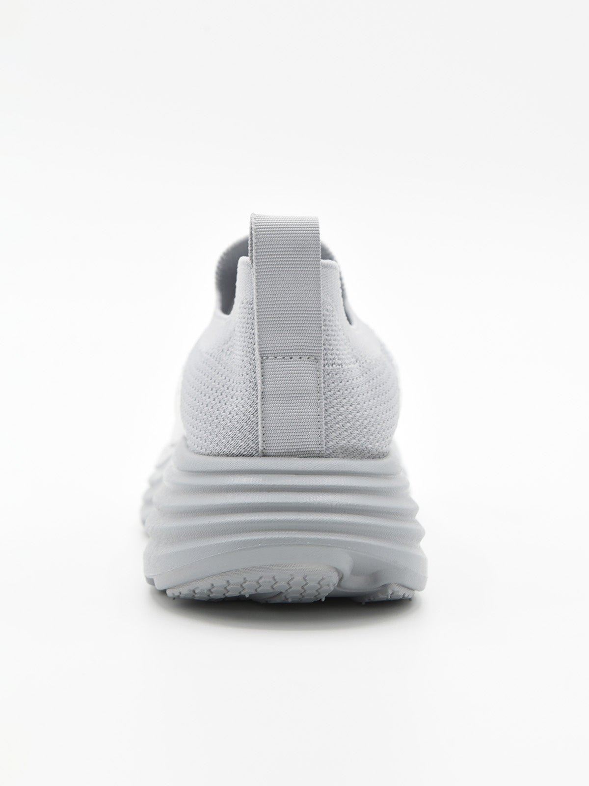 Zapatilla slip-on de punto knit en degradado gris con suela chunky ondulada gris y logo Nyrex en relieve.